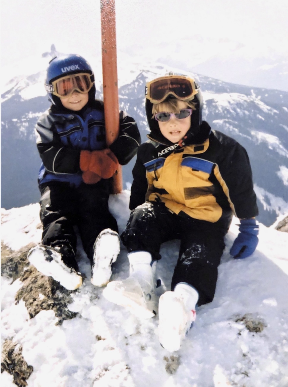 a young brodie and riley seger wearing ski suits at the top of whistler mountain