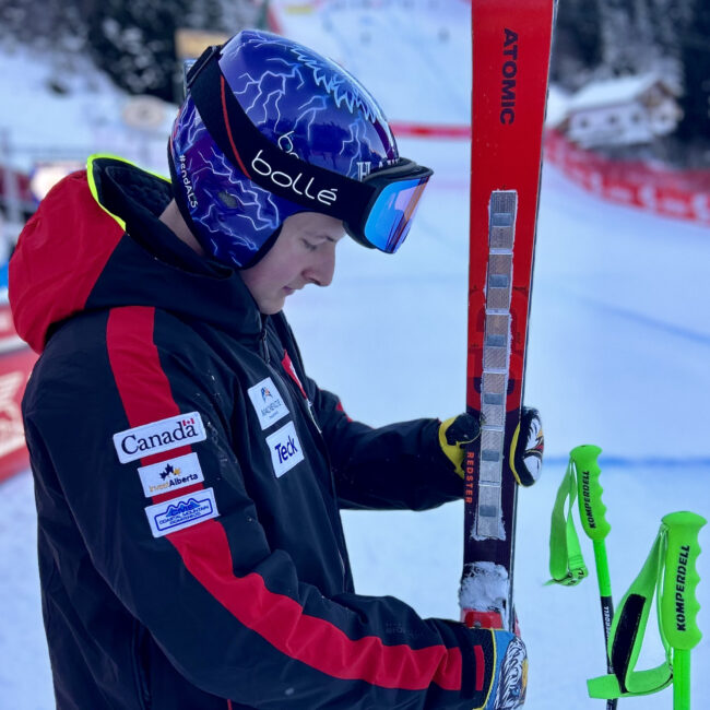 Brodie Seger picking up his skis in the finish area of the Val Gardena downhill course.